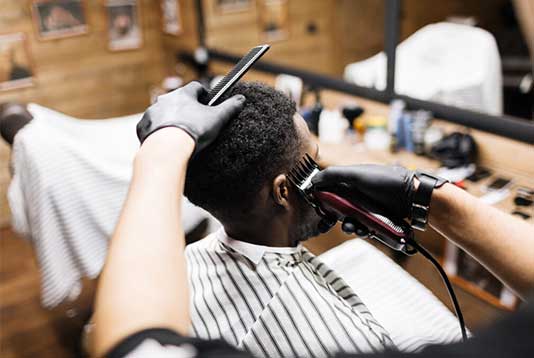 barber/stylist school in Maryland giving a customer a fade