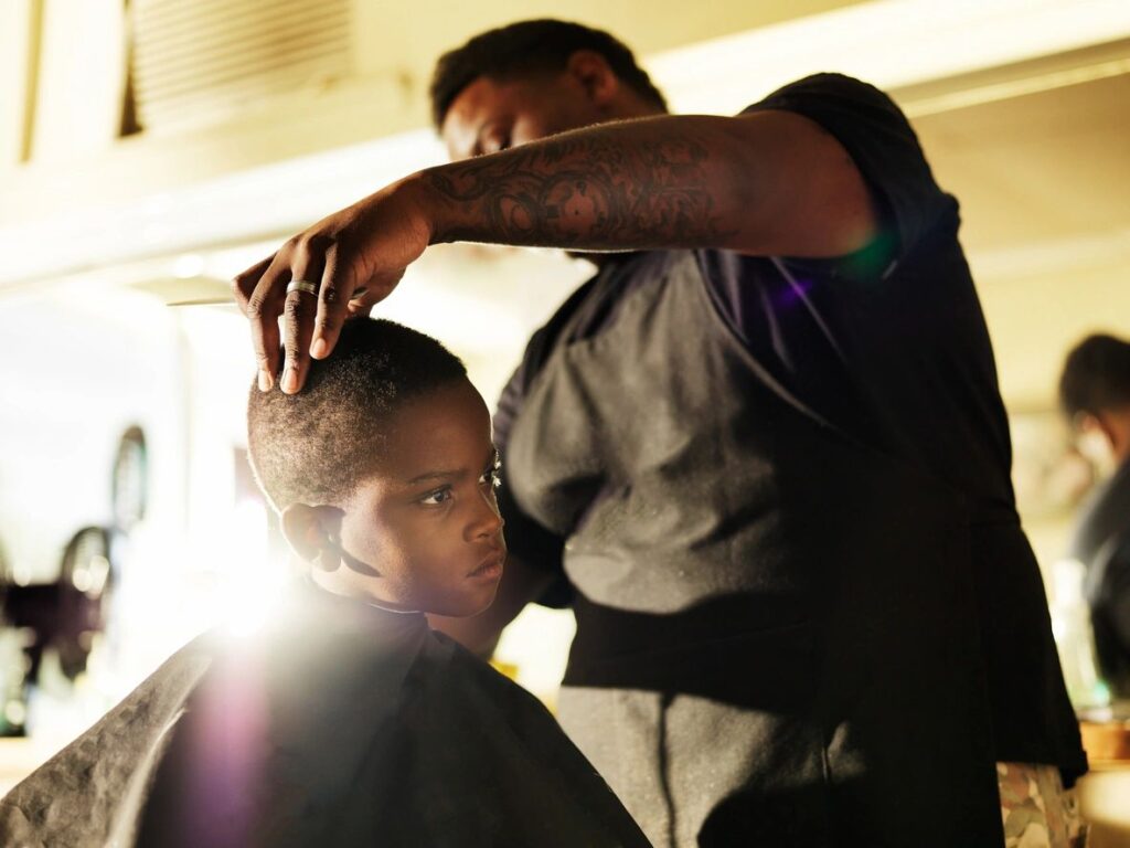 Barber Stylist in Maryland giving child a haircut